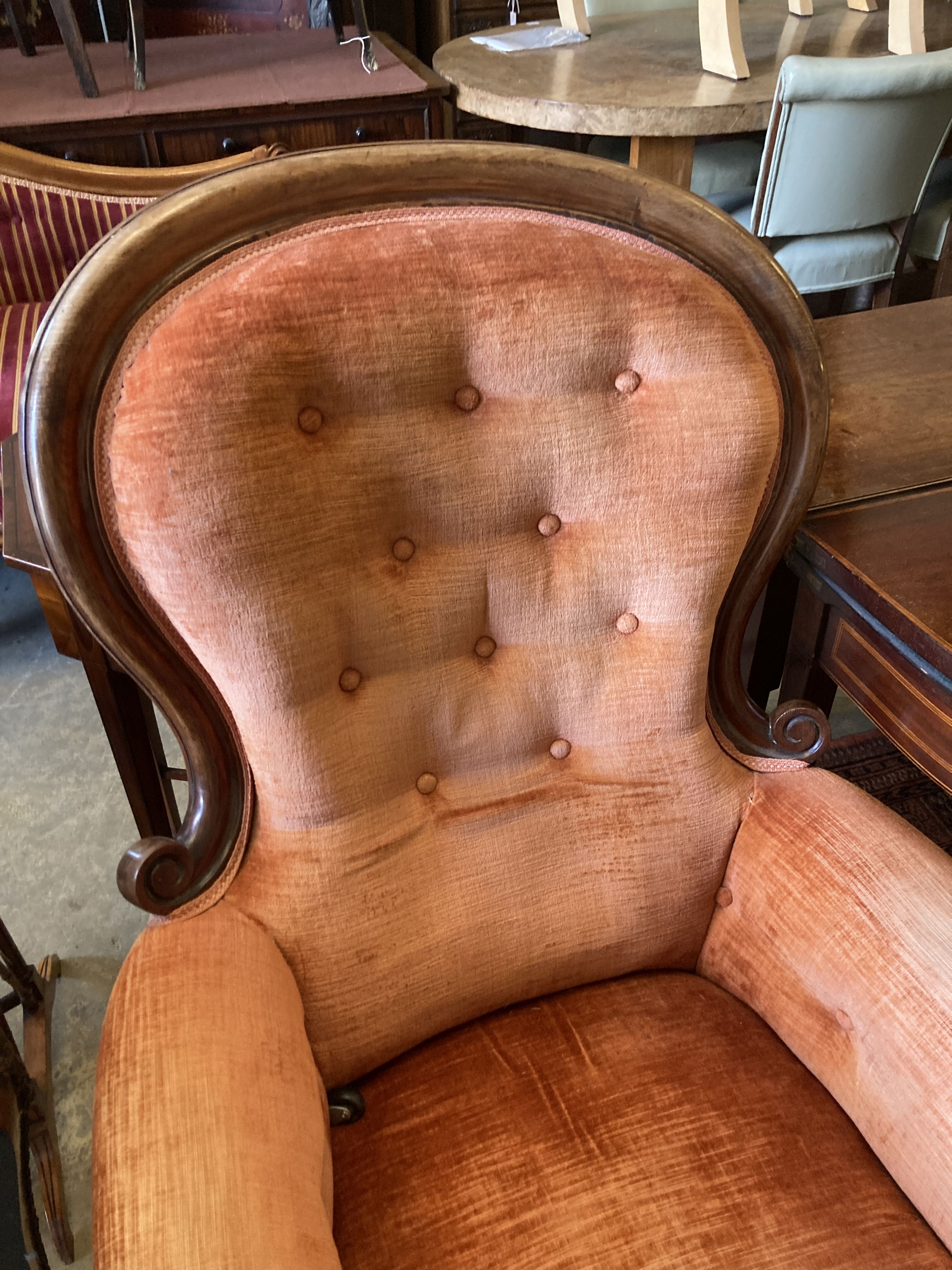 A Victorian carved mahogany spoonback armchair, width 72cm, depth 70cm, height 105cm